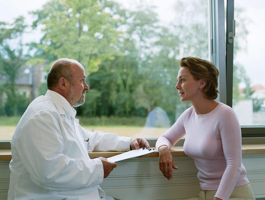 Male doctor meeting with female patient
