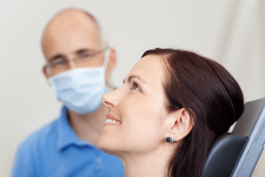 Smiling female patient in dentist chair