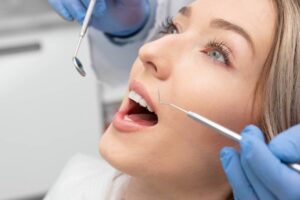150246267_l (1) blonde woman's teeth being observed by dentist